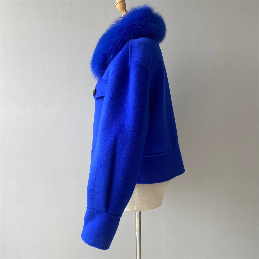 Blue jacket with fur collar on a mannequin against a plain background