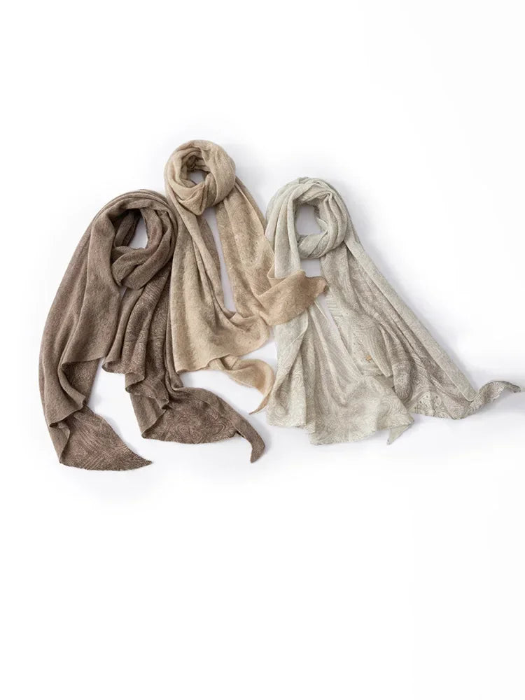 Three scarves in beige, brown, and light gray on a white background
