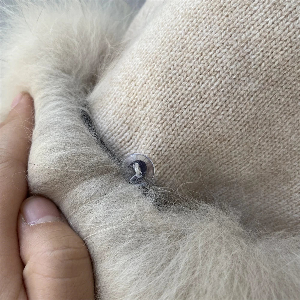 Close-up of a dog's paw with a small metal object embedded, held by a person.