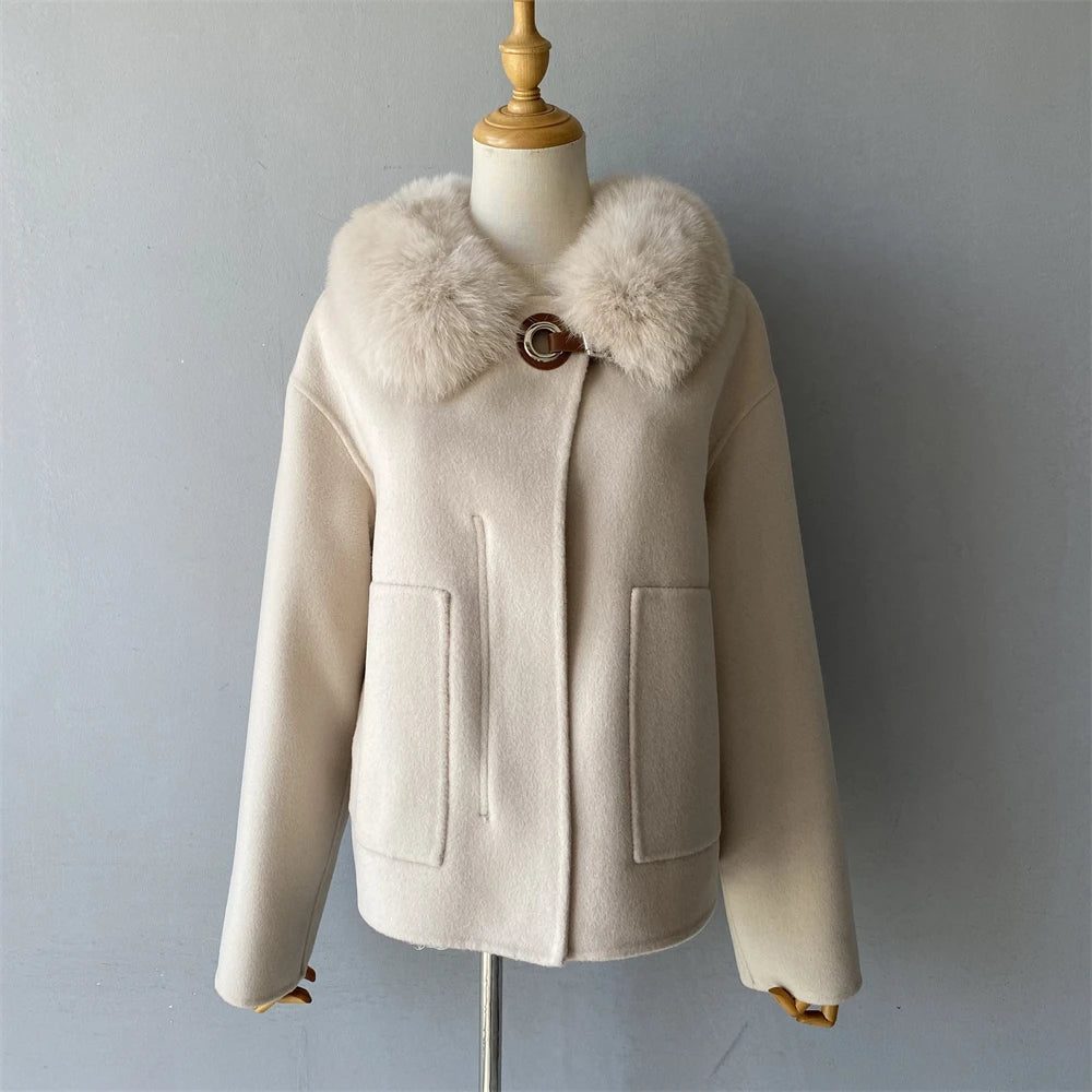 Beige coat with fur collar on a mannequin against a gray background