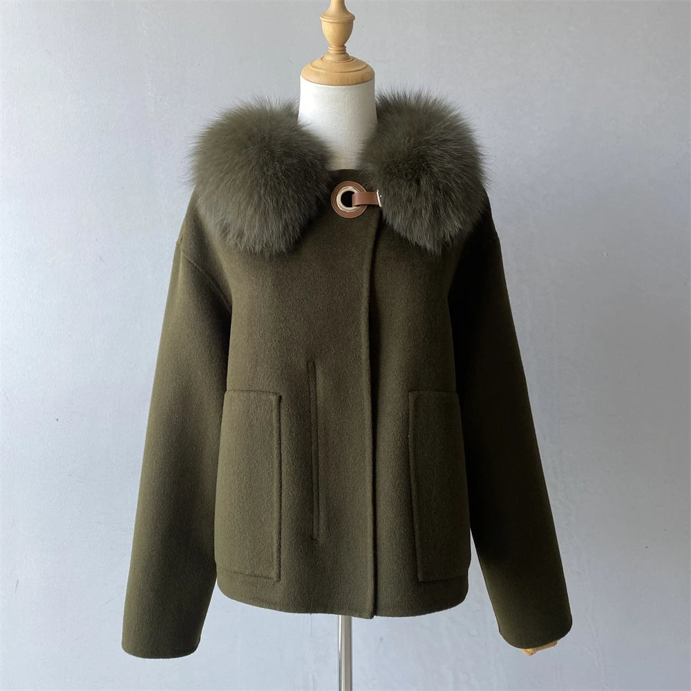 Green coat with fur collar on a mannequin against a plain background