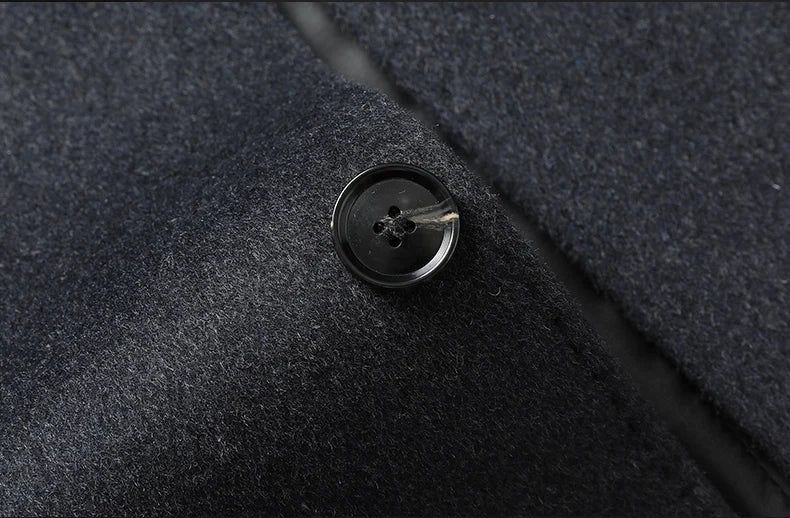 Close-up of a button on a textured dark fabric surface