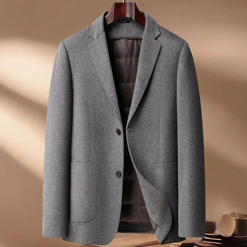 Gray blazer on a hanger against a beige background