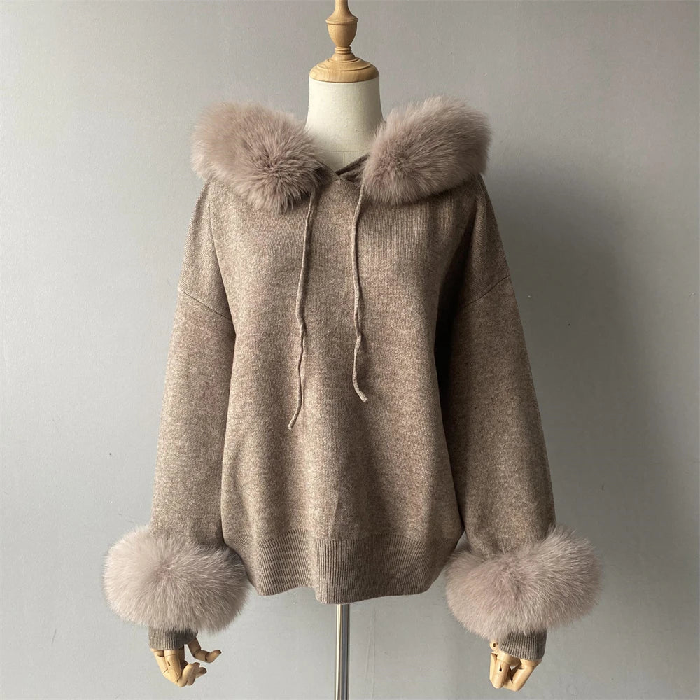 Beige hooded coat with fur trim on a mannequin against a plain background