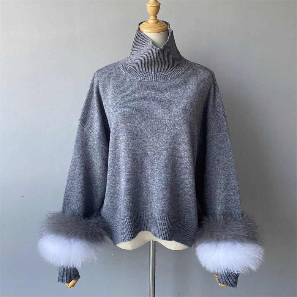 Gray sweater with fur cuffs on a mannequin against a plain background