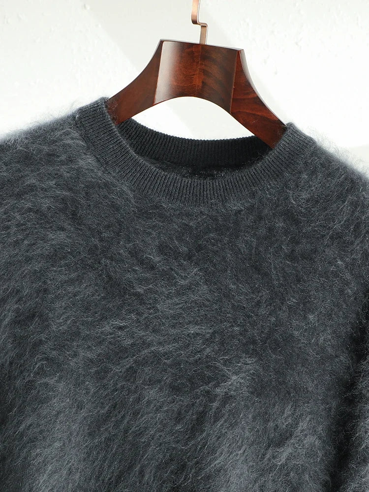 Gray fluffy sweater on a wooden hanger against a white background