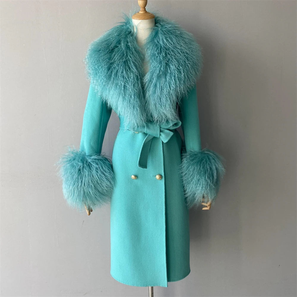 Teal coat with fur trim on a mannequin against a plain background