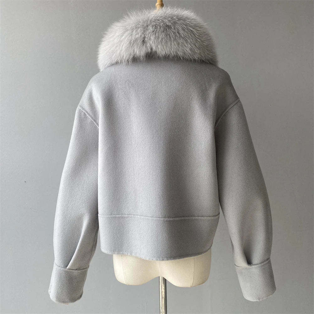 Gray jacket with fur collar on a mannequin against a gray background
