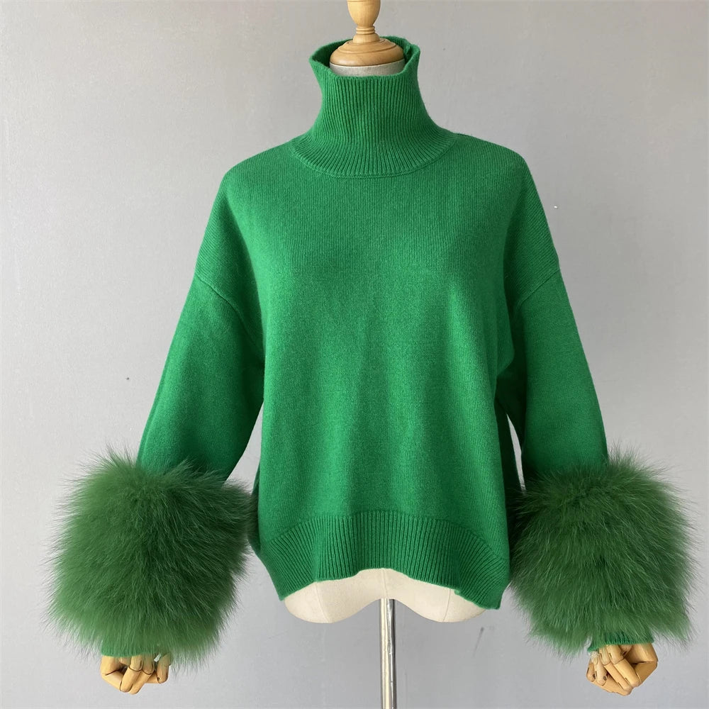 Green sweater with furry cuffs on a mannequin against a gray background