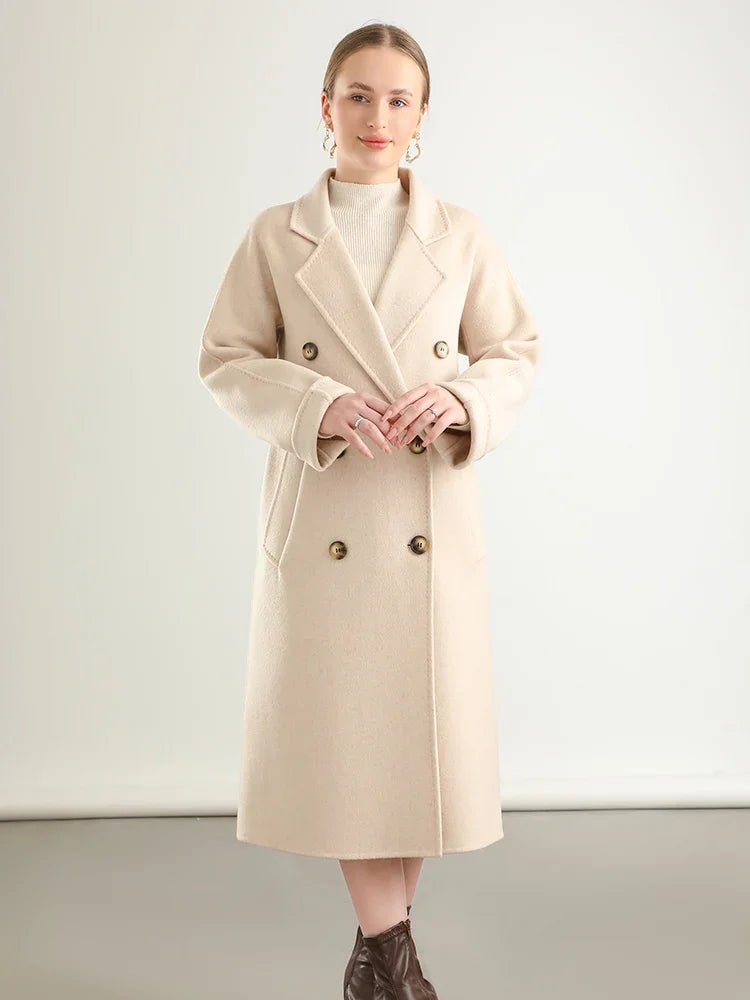 Woman wearing a beige coat against a plain background