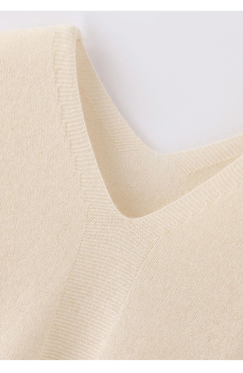 Close-up of a beige sweater with a V-neck on a white background