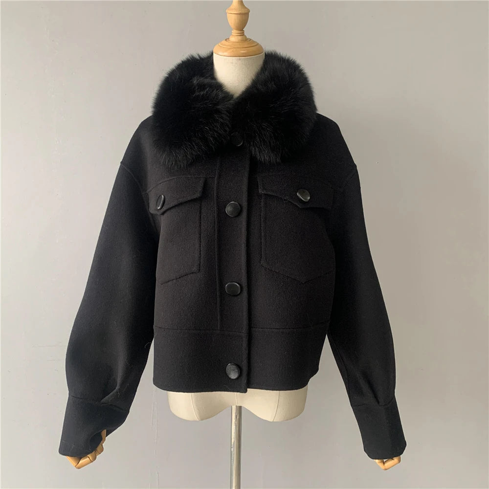 Black jacket with fur collar on a mannequin against a plain background