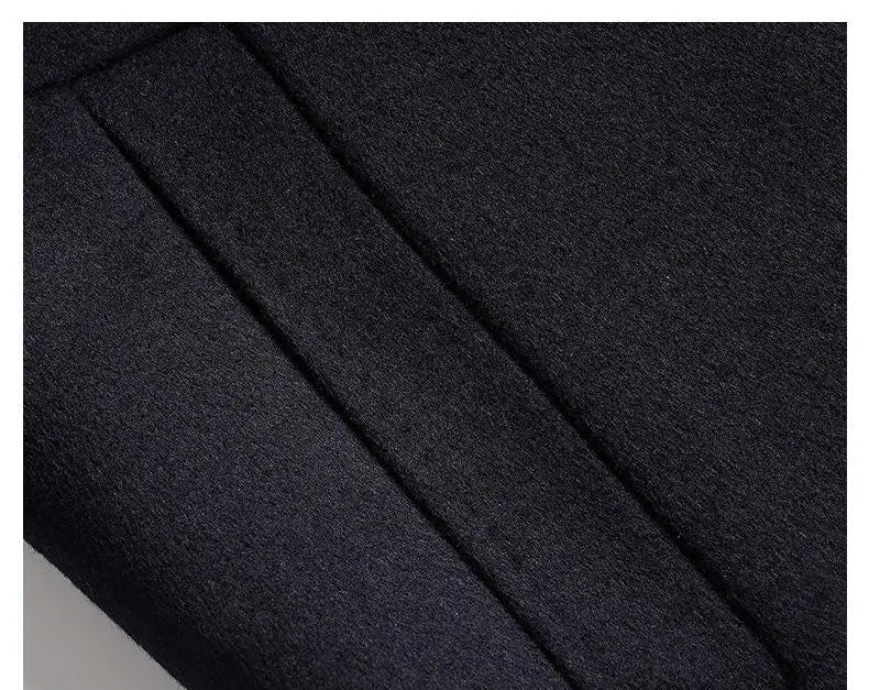 Close-up of dark fabric with a visible seam on a black background