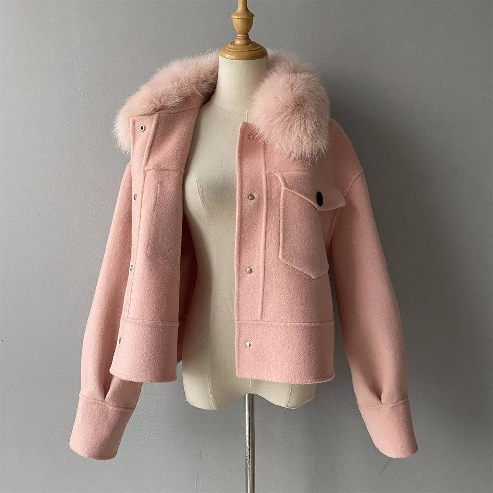 Pink jacket with fur hood on a mannequin against a gray background