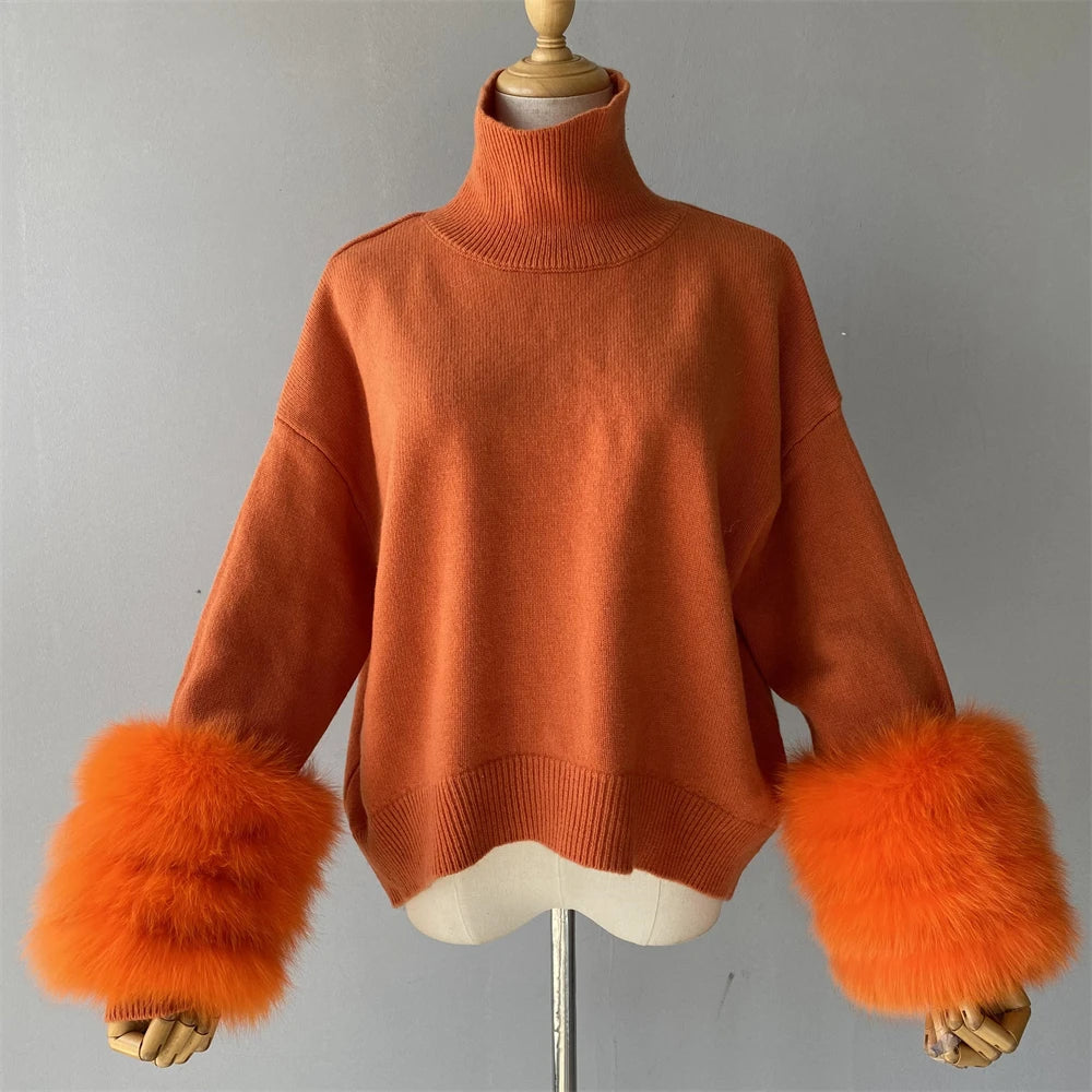 Orange sweater with furry cuffs on a mannequin against a gray background