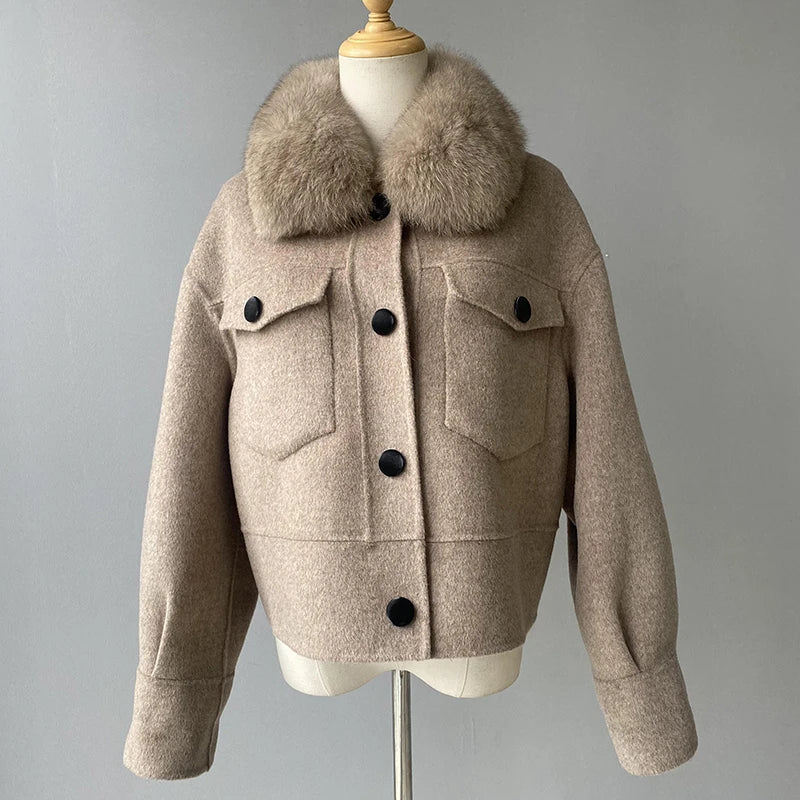 Beige jacket with fur collar on a mannequin against a gray background