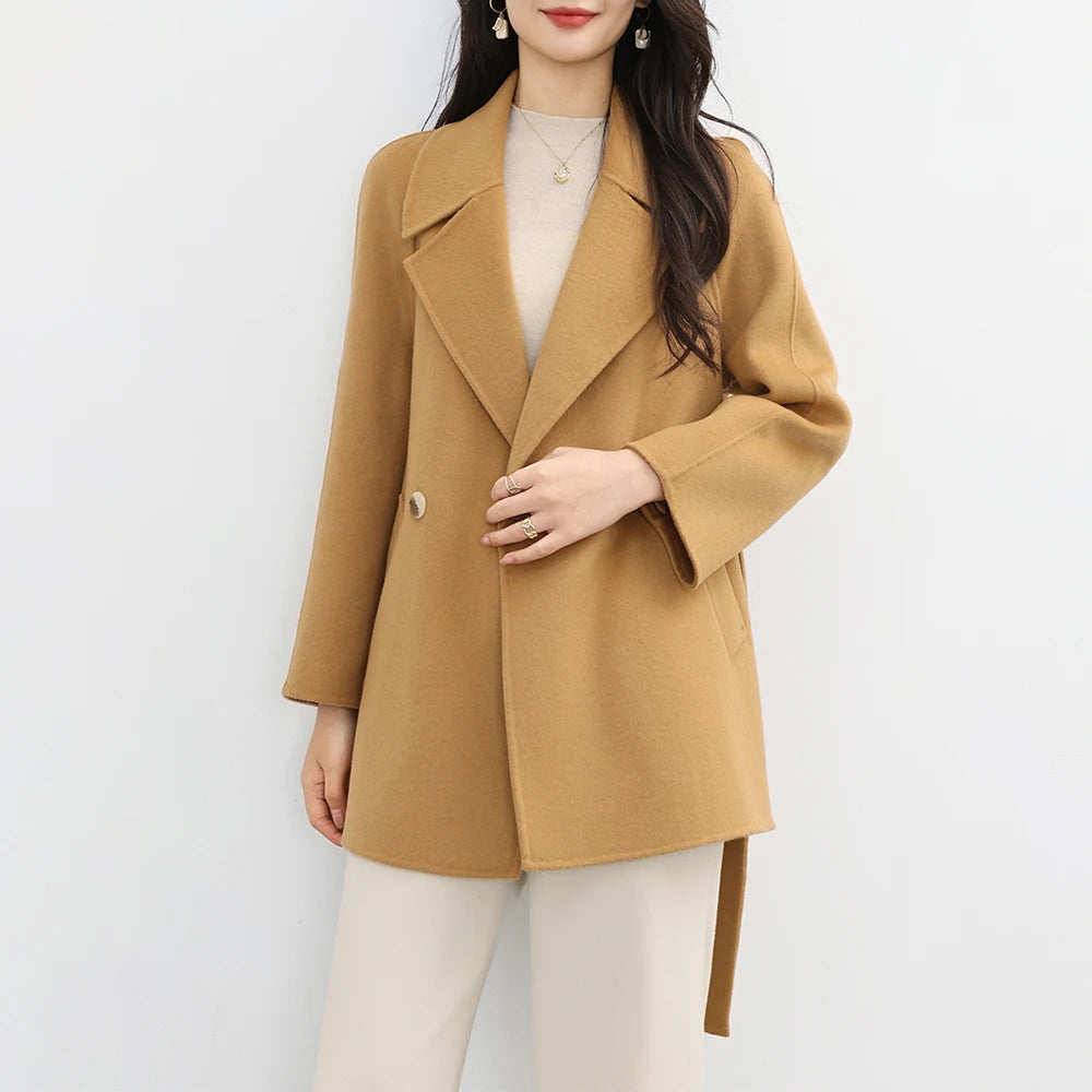 Woman wearing a tan coat on a white background
