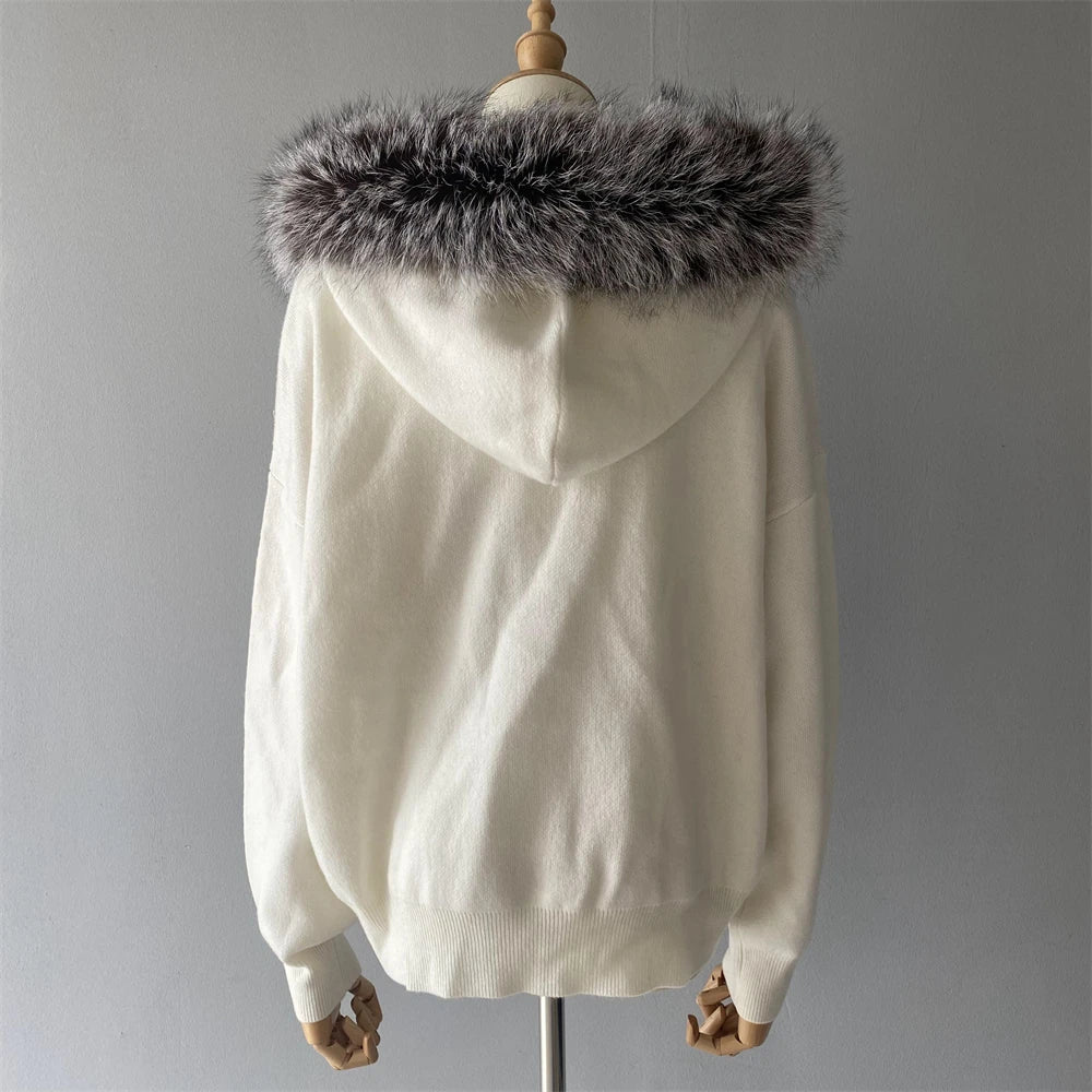 White hoodie with fur-lined hood on a mannequin against a gray background