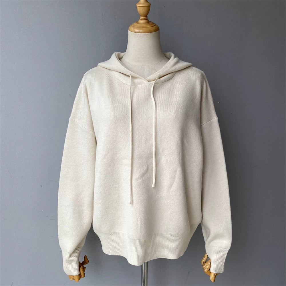 White hoodie on a mannequin against a gray background