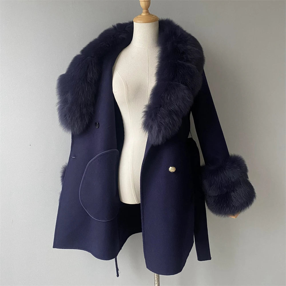 Navy blue coat with fur trim on a mannequin against a plain background