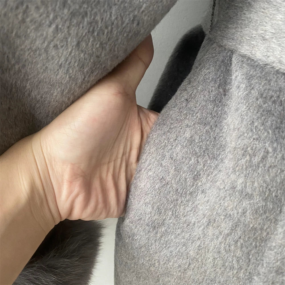 Close-up of a hand holding gray fabric