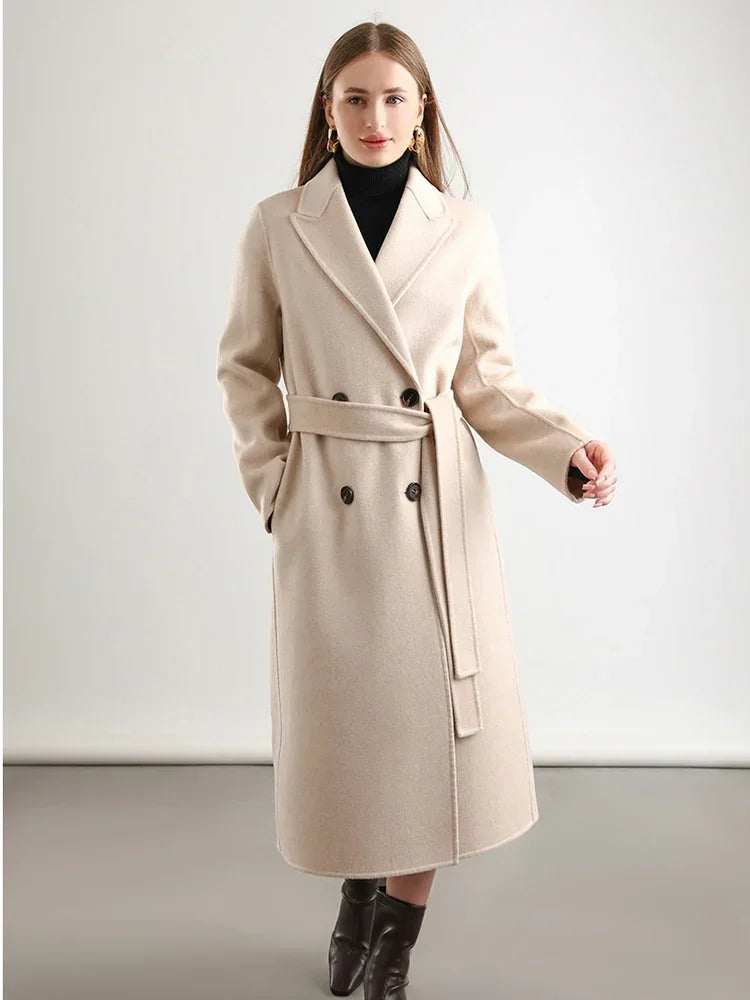 Woman wearing a beige coat on a plain background