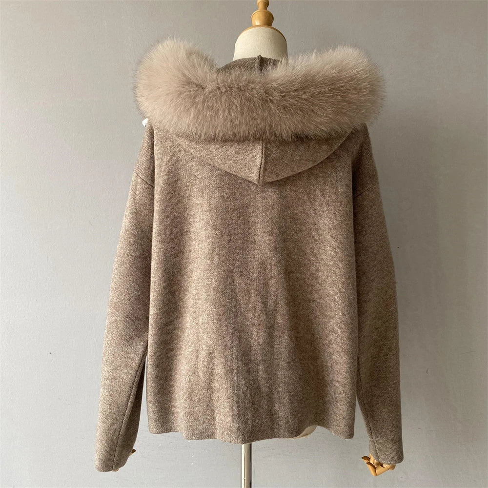 Brown coat with fur hood on a mannequin against a plain background