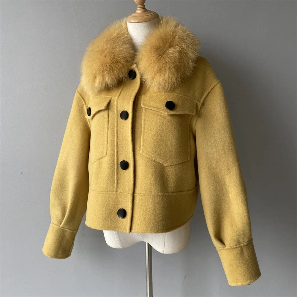 Yellow jacket with fur collar on a mannequin against a gray background