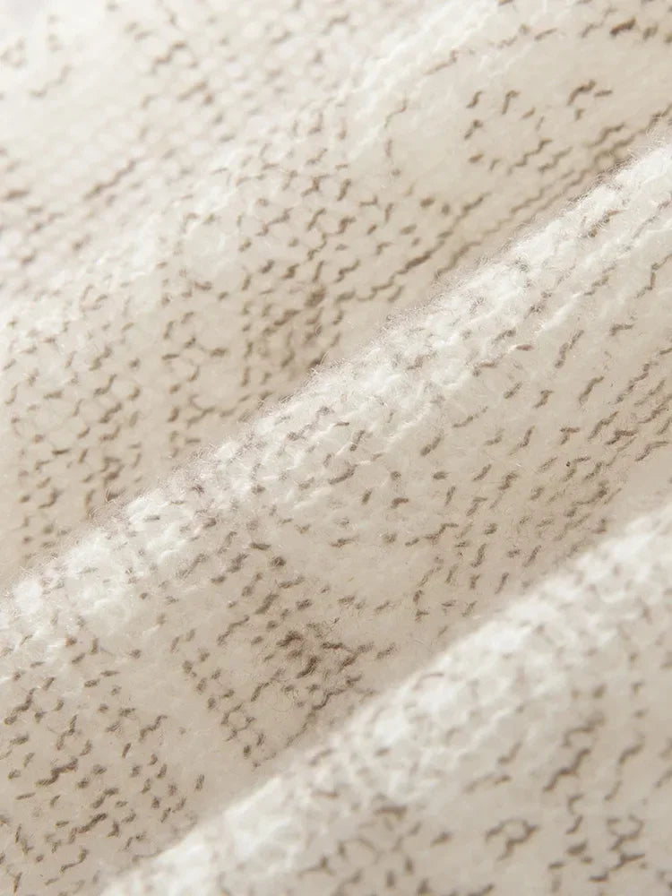 Close-up of textured beige fabric with a subtle pattern
