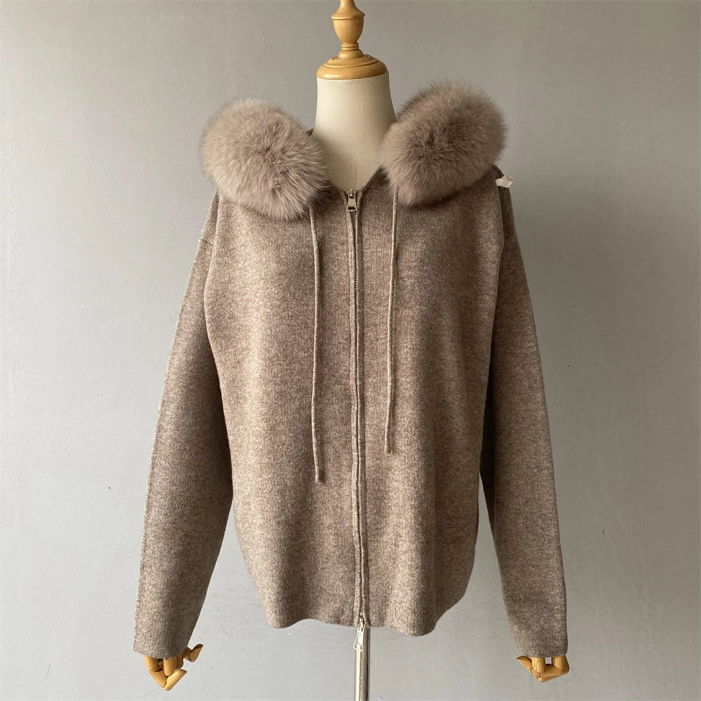 Brown coat with fur hood on a mannequin against a plain background