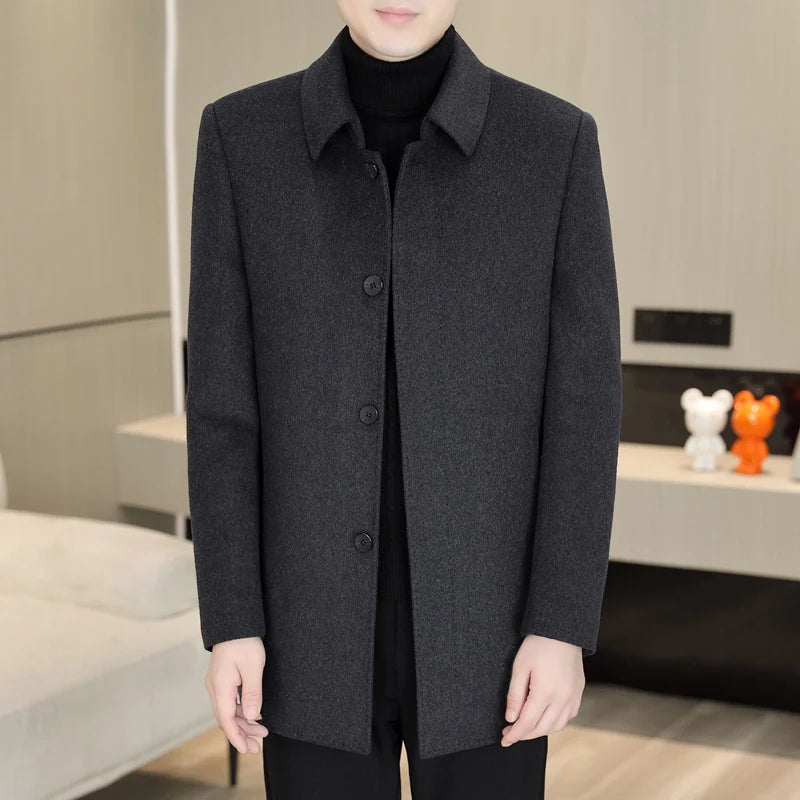 Person wearing a dark gray coat in an indoor setting