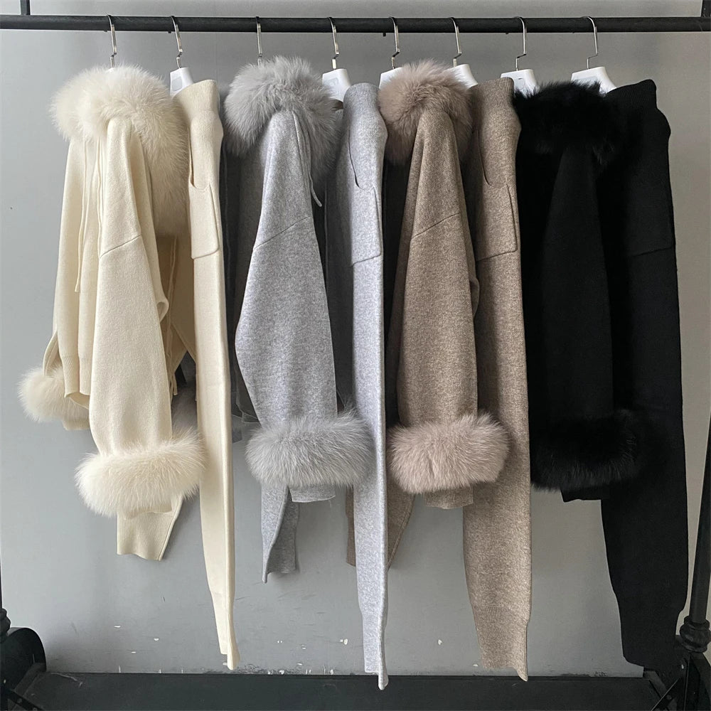 Row of coats with fur trim hanging on a rack against a neutral background