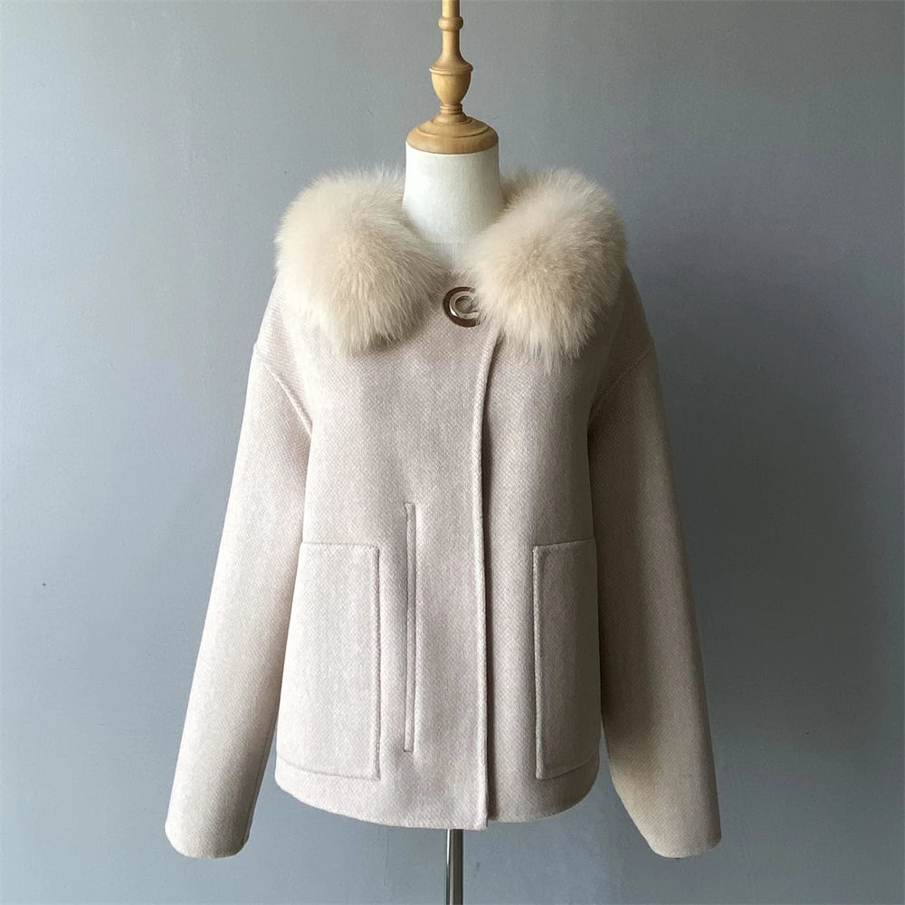 Beige coat with fur collar on a mannequin against a gray background