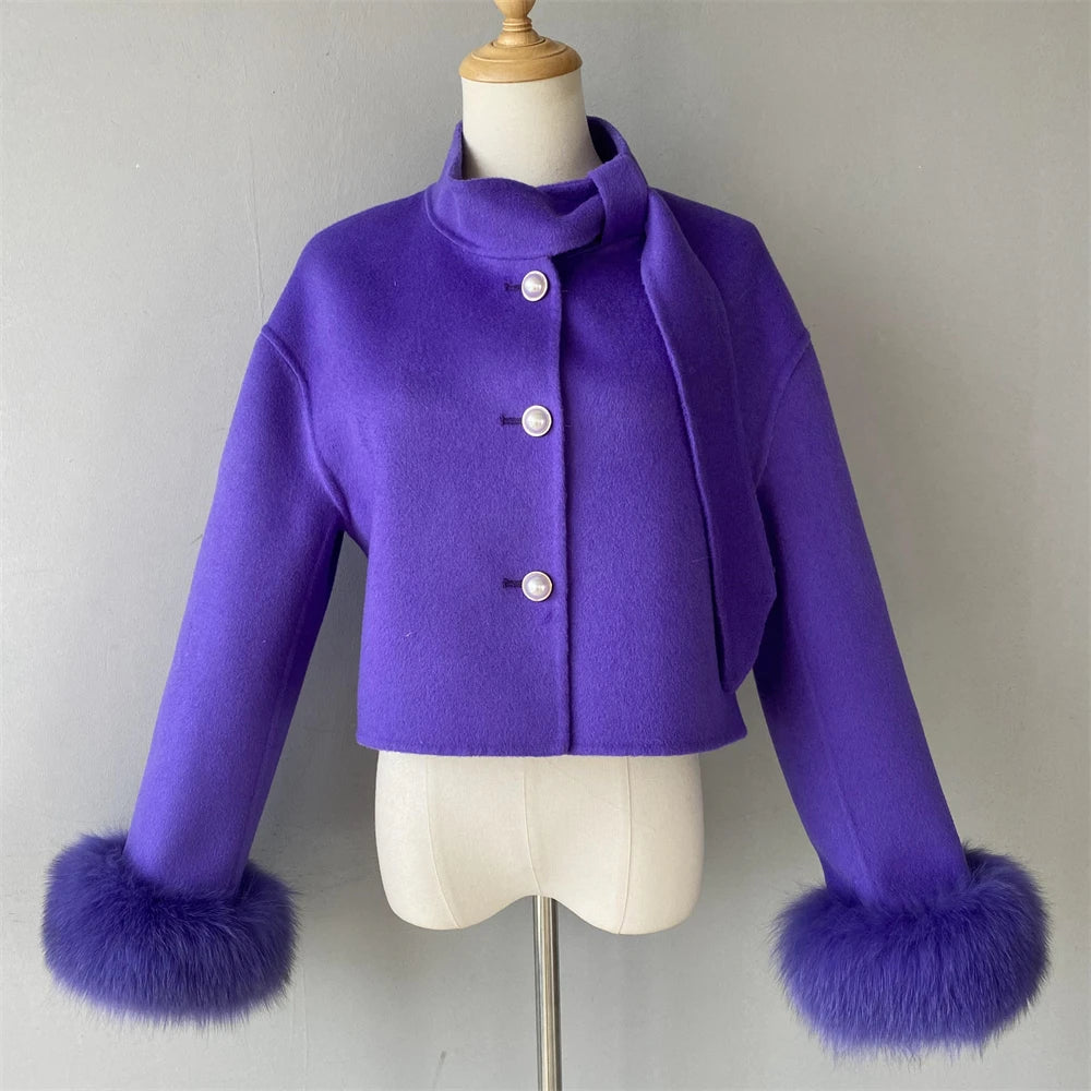 Purple coat with fur cuffs on a mannequin against a gray background