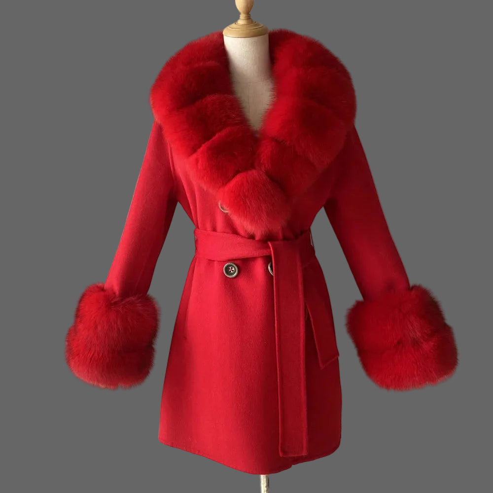 Red coat with fur accents on a mannequin against a plain background