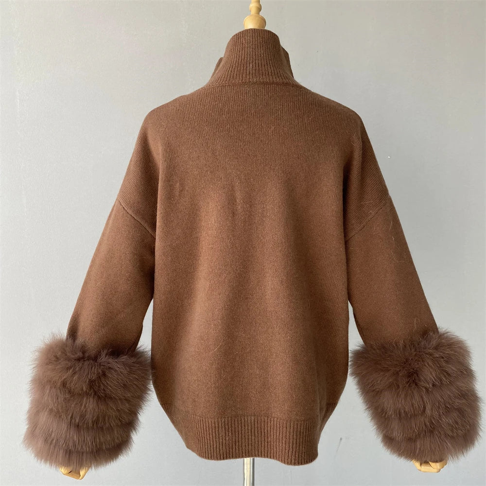 Brown sweater with fur cuffs on a mannequin against a plain background