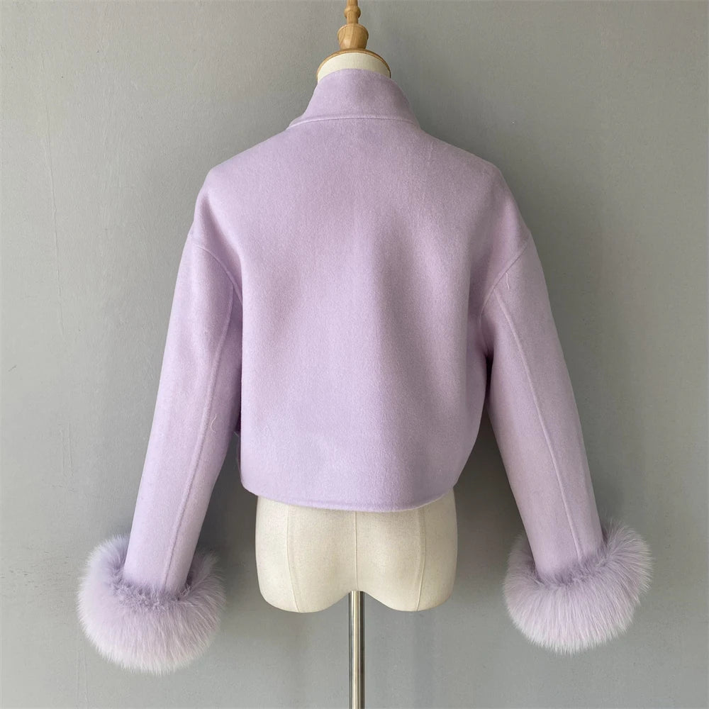 Lavender jacket with fur cuffs on a mannequin against a gray background