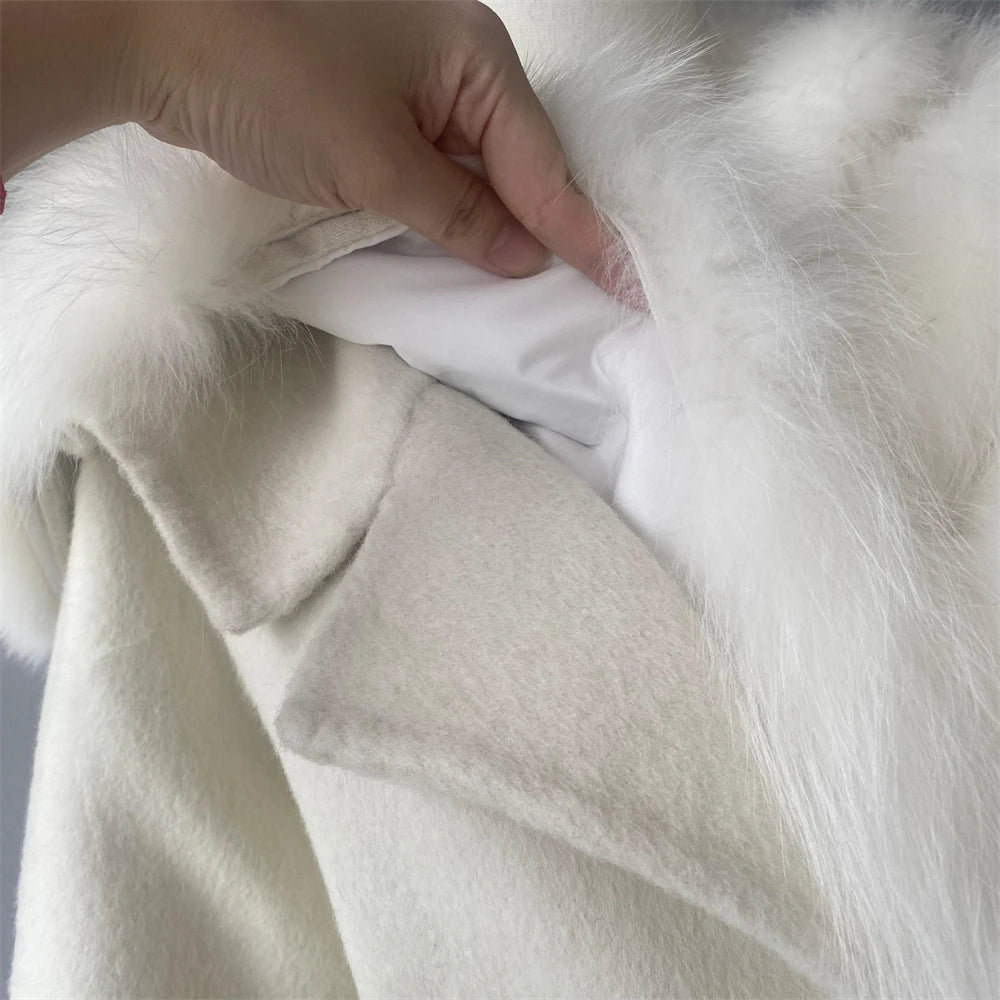 Close-up of a hand holding white fur fabric
