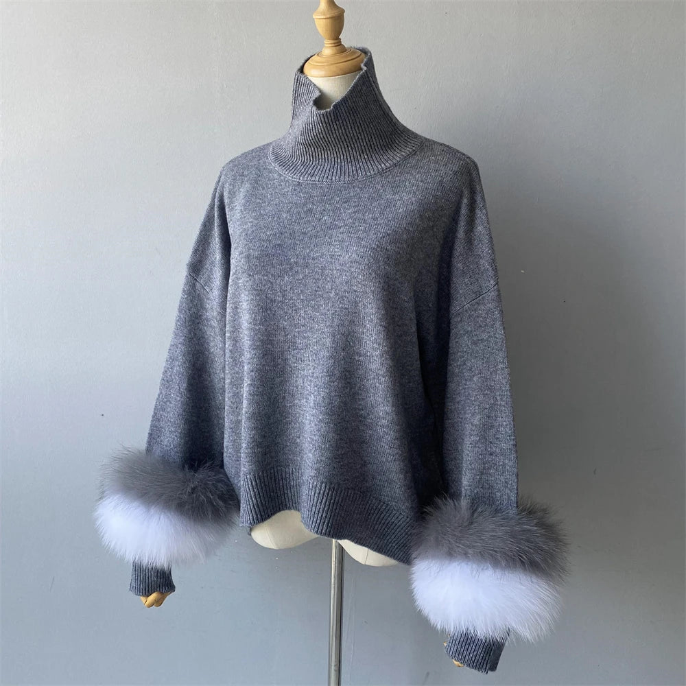 Gray sweater with fur cuffs on a mannequin against a plain background
