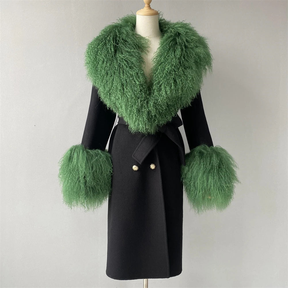 Black coat with green fur trim on a mannequin against a plain background