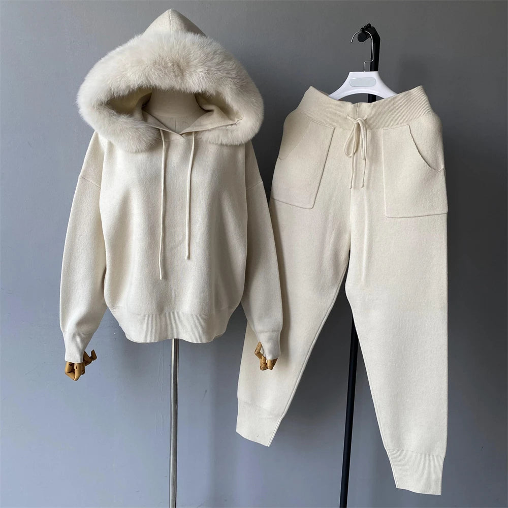 Beige hoodie with fur-lined hood and matching pants on a gray background