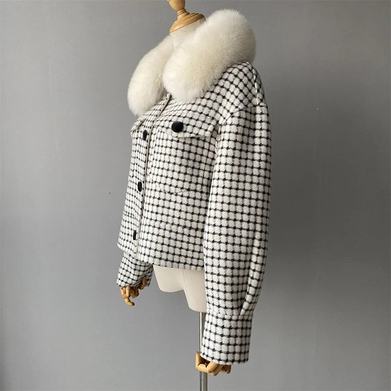 Black and white checkered coat with fur collar on a mannequin against a gray background