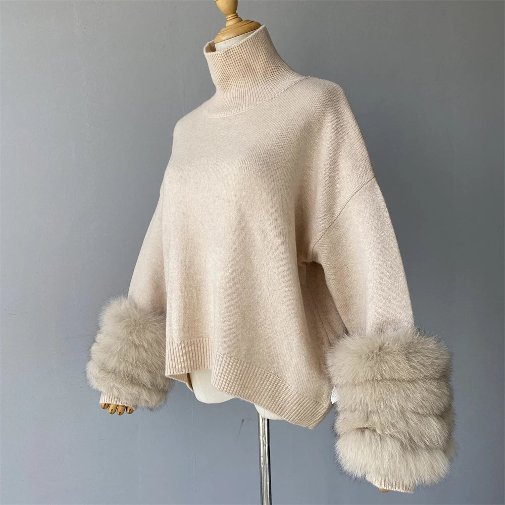Beige sweater with fur cuffs on a mannequin against a gray background