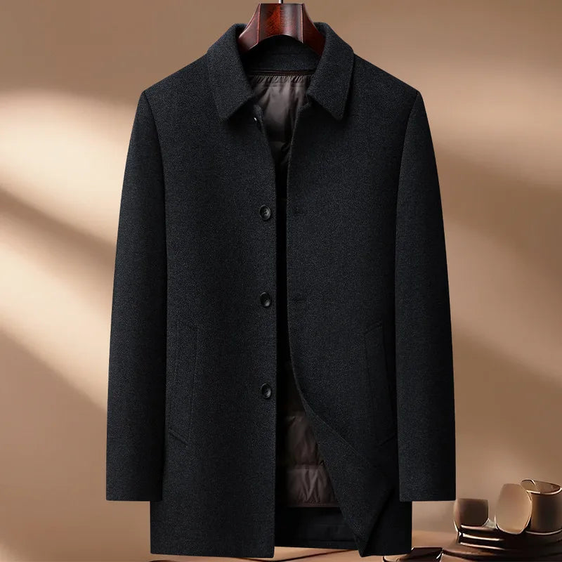 Dark gray coat on a hanger against a beige background