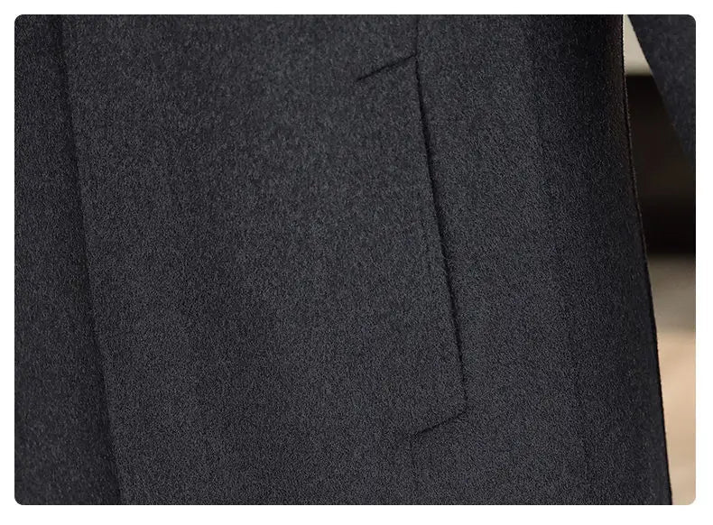 Close-up of a dark gray fabric with a pocket, on a blurred background.