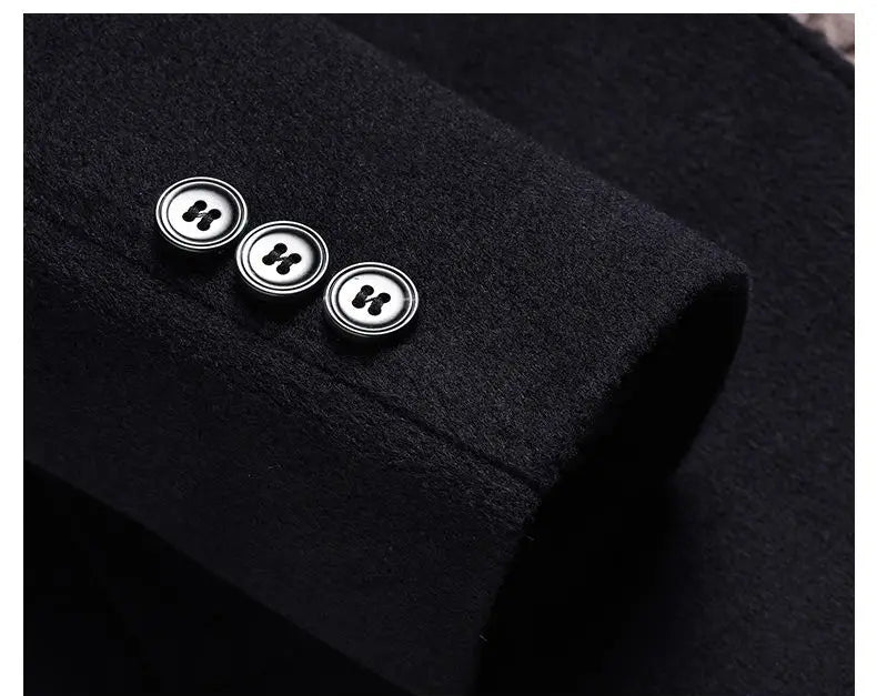 Close-up of a black garment with three buttons on the sleeve.