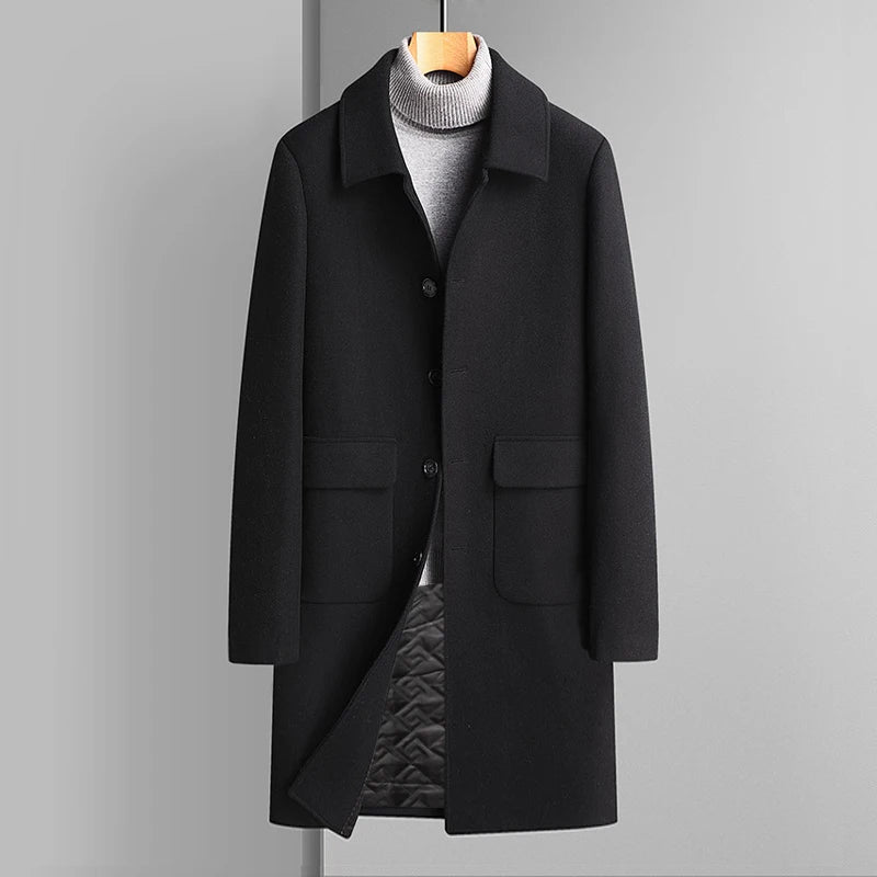 Black coat on a hanger against a gray background
