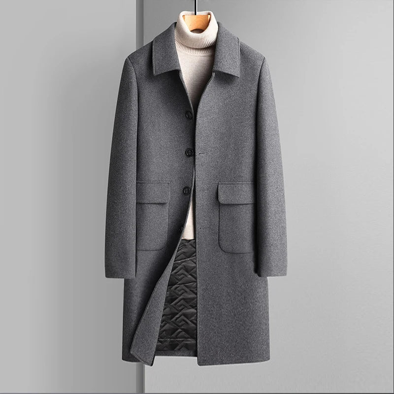 Gray coat on a hanger against a gray background