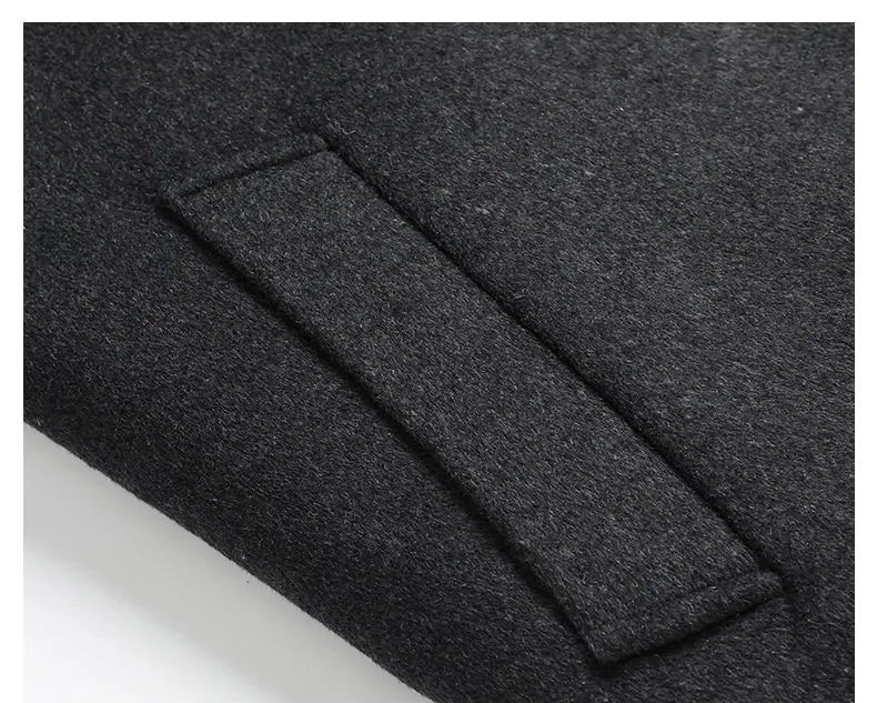Close-up of a dark gray fabric with a pocket detail on a black background.