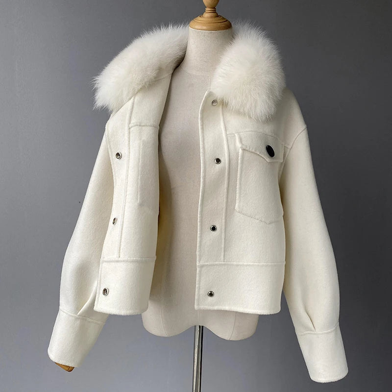 White jacket with fur hood on a mannequin against a gray background